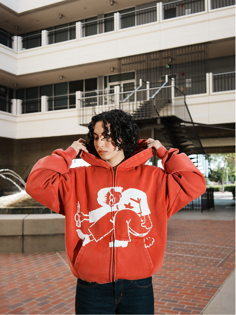 female model wearing Sketch & Fart red hoodie